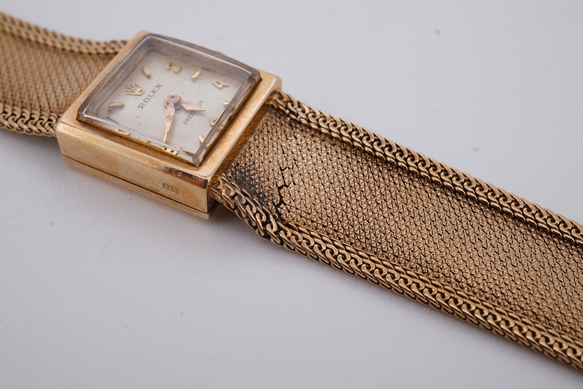 A lady's 1960's 9ct gold Rolex Precision manual wind wrist watch, with square dial, on an integral 9ct gold bracelet, the clasp with Rolex crown, overall length 15cm, gross weight 22 grams (bracelet a.f.)